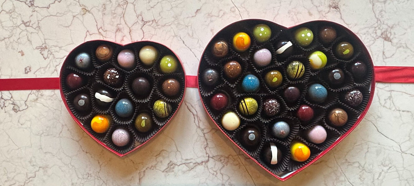 
                  
                    An open 16 and 30 piece heart shaped box of colorful chocolate handcrafted bonbons
                  
                