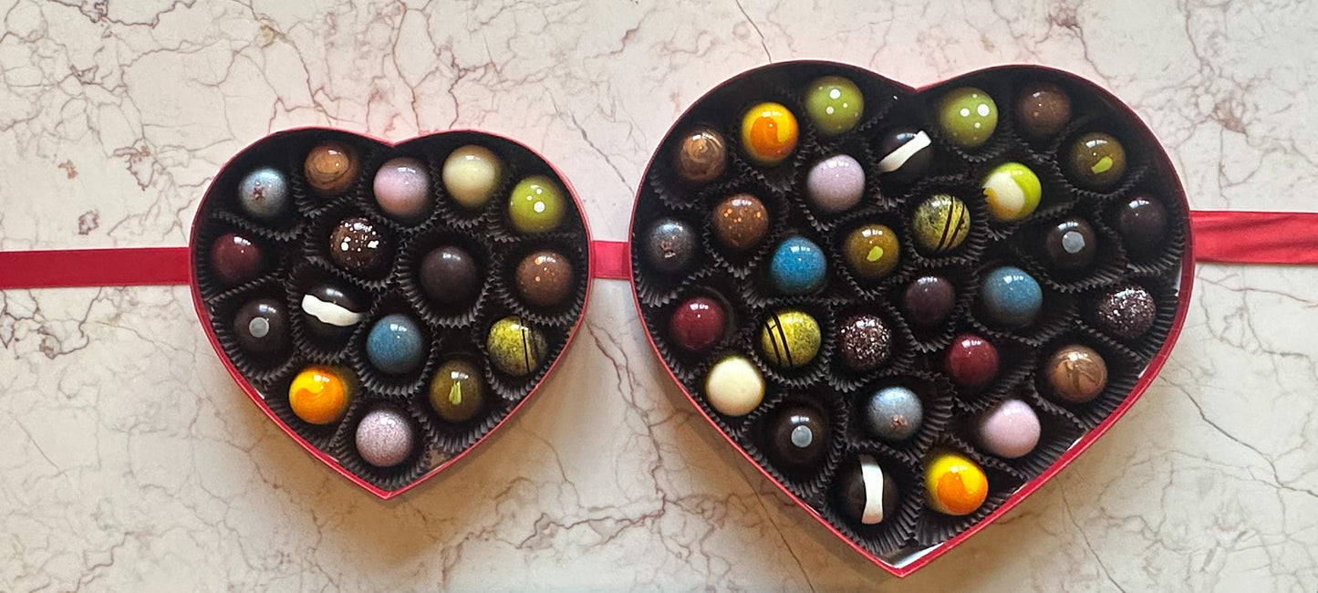 
                  
                    An open 16 and 30 piece heart shaped box of colorful chocolate handcrafted bonbons
                  
                